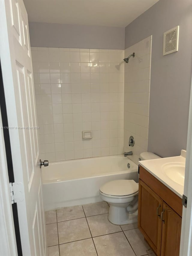 full bathroom with tile patterned floors, vanity, toilet, and tiled shower / bath combo