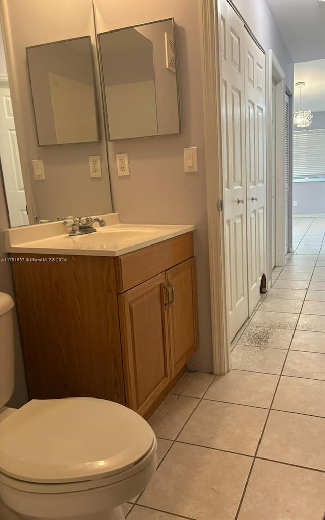 bathroom featuring tile patterned floors, vanity, and toilet