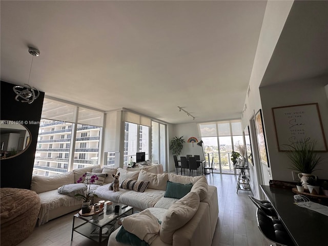 living room with light hardwood / wood-style flooring and floor to ceiling windows