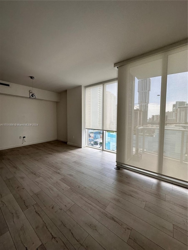 unfurnished room with light hardwood / wood-style floors