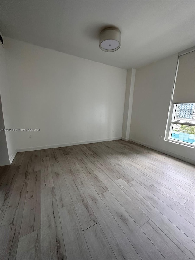 empty room with light hardwood / wood-style floors