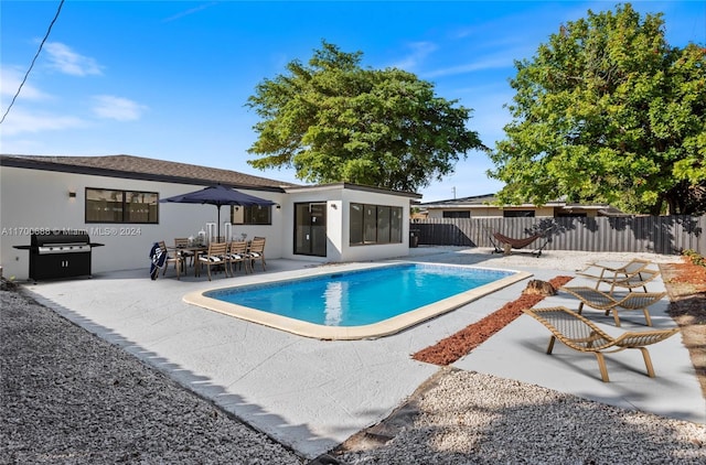 view of pool with a patio and grilling area