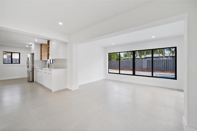 unfurnished living room with sink