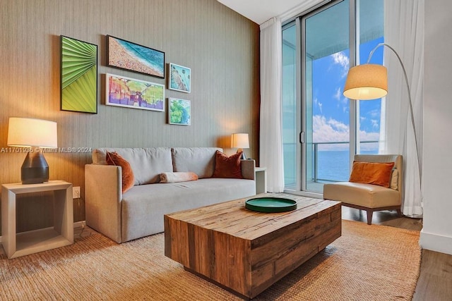 living room with a water view and light wood-type flooring