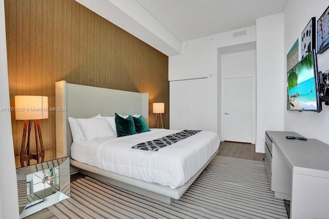 bedroom featuring light hardwood / wood-style flooring and a closet