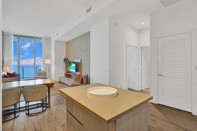 kitchen with a kitchen island and light hardwood / wood-style floors