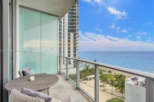 balcony featuring a water view and a view of the beach