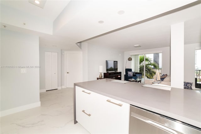 17145 N Bay Rd Unit 4607, Sunny Isles Beach, FL 33160 - kitchen featuring light marble finish flooring, white cabinets, light countertops, a peninsula, and open floor plan