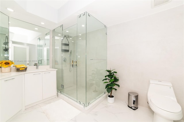 bathroom featuring vanity, toilet, and a shower with shower door