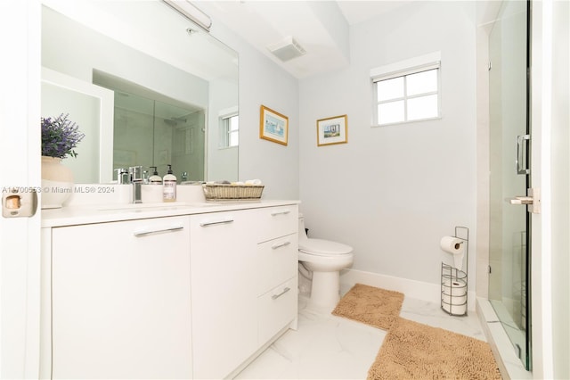 bathroom featuring an enclosed shower, vanity, toilet, and plenty of natural light