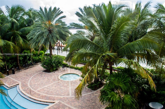 view of swimming pool with a water view