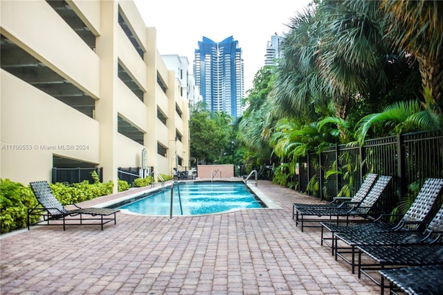 view of swimming pool featuring a patio area