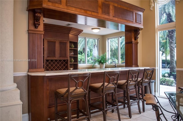 bar featuring light tile patterned floors