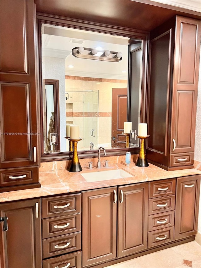 bathroom with vanity, tile patterned floors, an enclosed shower, and ornamental molding