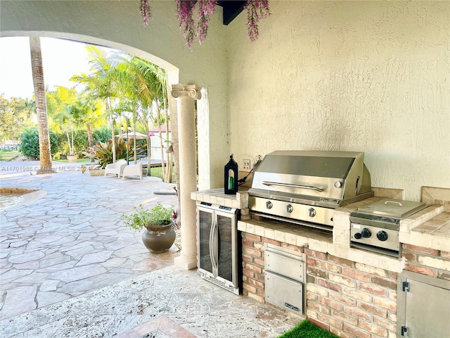 view of patio with grilling area and an outdoor kitchen