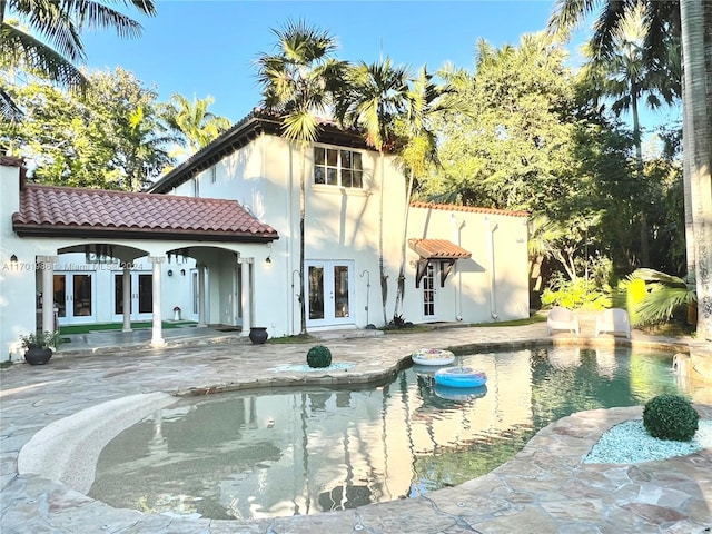 rear view of property featuring a patio area and french doors