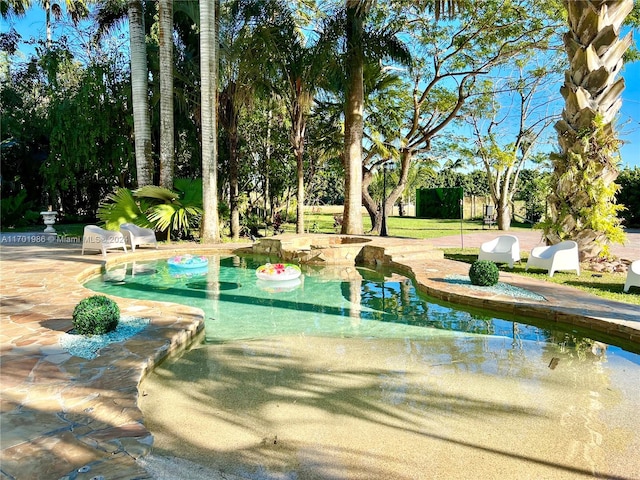 view of community featuring a patio area and a pool