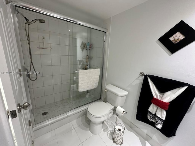 bathroom with tile patterned floors, toilet, and walk in shower