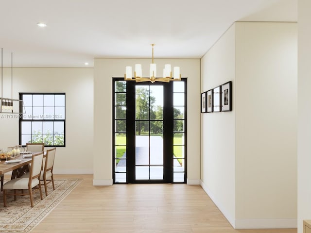 interior space featuring light hardwood / wood-style floors and a notable chandelier