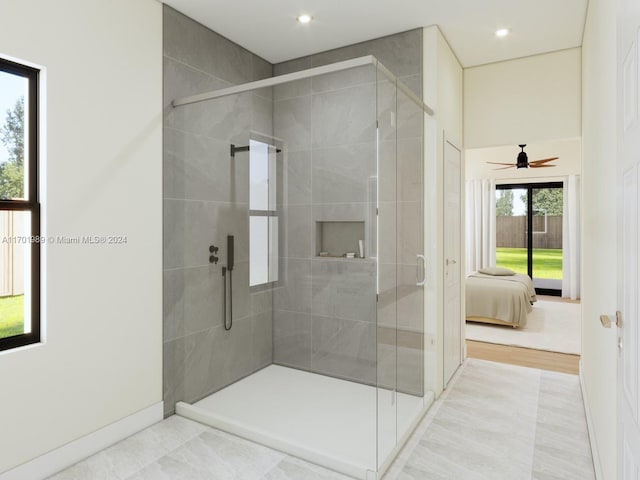 bathroom with walk in shower, hardwood / wood-style floors, and ceiling fan