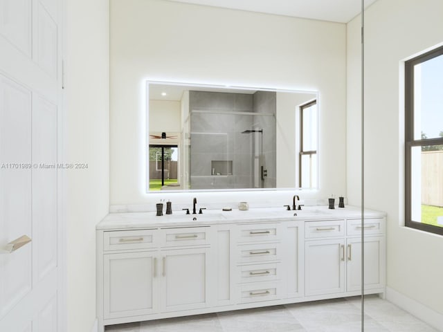 bathroom featuring a shower with door and vanity