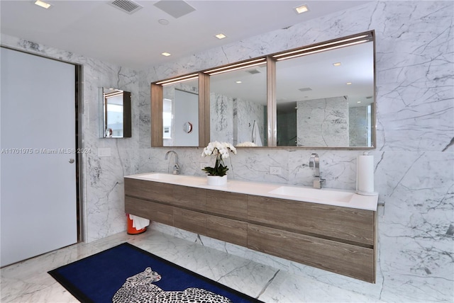 bathroom with vanity and tile walls