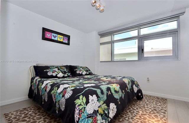 bedroom with hardwood / wood-style floors