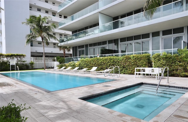 view of pool with a patio area and a hot tub