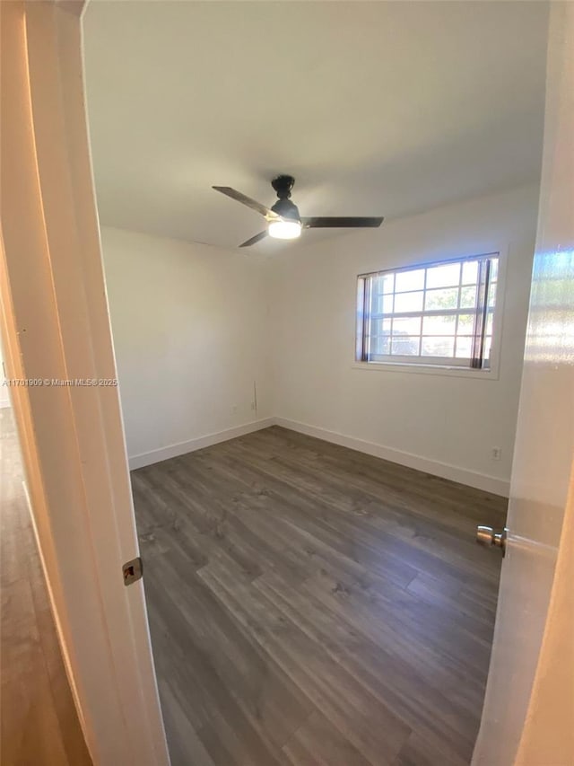 unfurnished room featuring ceiling fan and dark hardwood / wood-style flooring