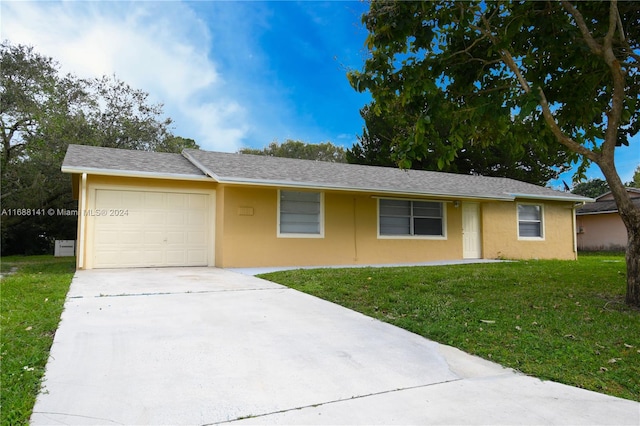 ranch-style home with a front yard and a garage