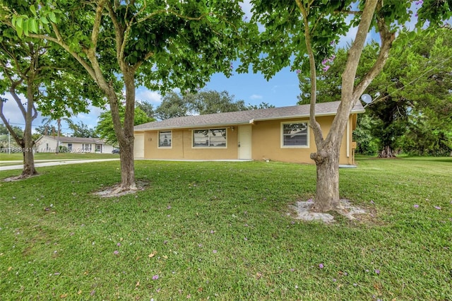 1101 SW Addie St, Port St Lucie, FL 34983 - ranch-style house with stucco siding and a front yard