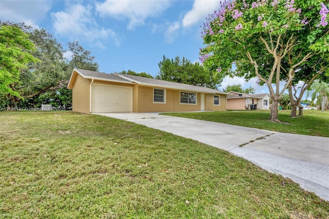 1101 SW Addie St, Port St Lucie, FL 34983 - ranch-style home with an attached garage, stucco siding, driveway, and a front lawn