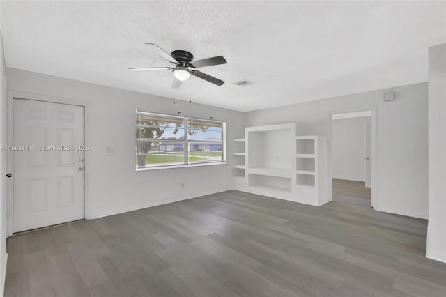 1101 SW Addie St, Port St Lucie, FL 34983 - unfurnished living room with ceiling fan, wood finished floors, and a textured ceiling