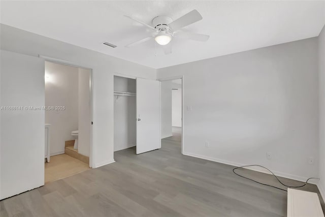 1101 SW Addie St, Port St Lucie, FL 34983 - unfurnished bedroom featuring light wood finished floors, a closet, ensuite bathroom, and ceiling fan