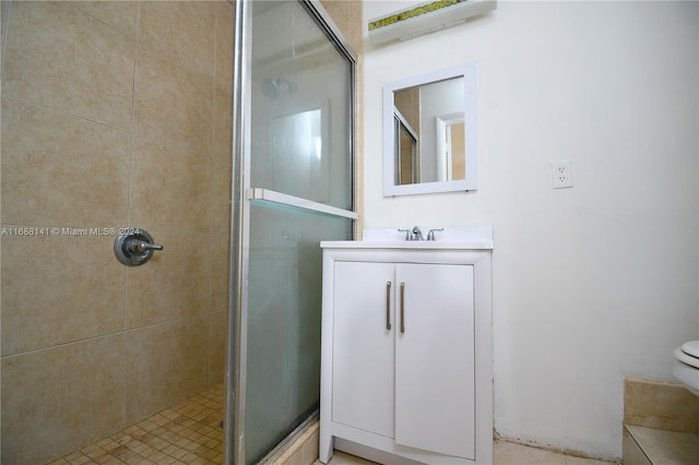 bathroom featuring vanity, toilet, and an enclosed shower