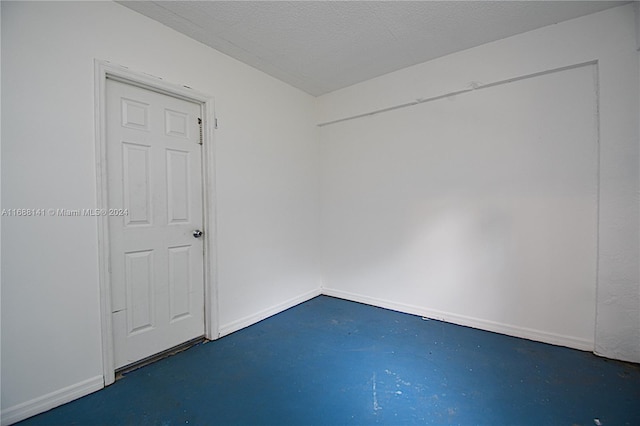 spare room with a textured ceiling