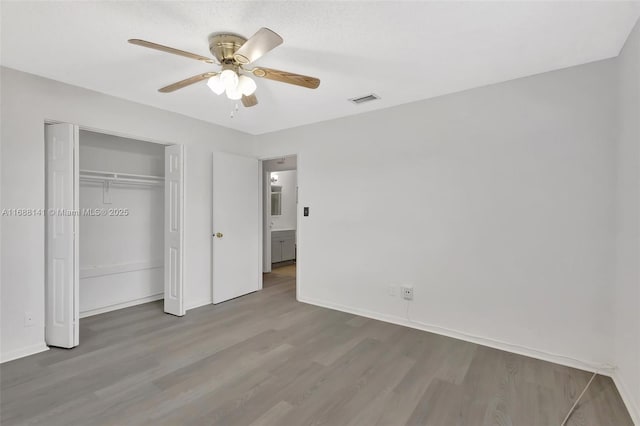 1101 SW Addie St, Port St Lucie, FL 34983 - unfurnished bedroom featuring wood finished floors, a closet, and a ceiling fan