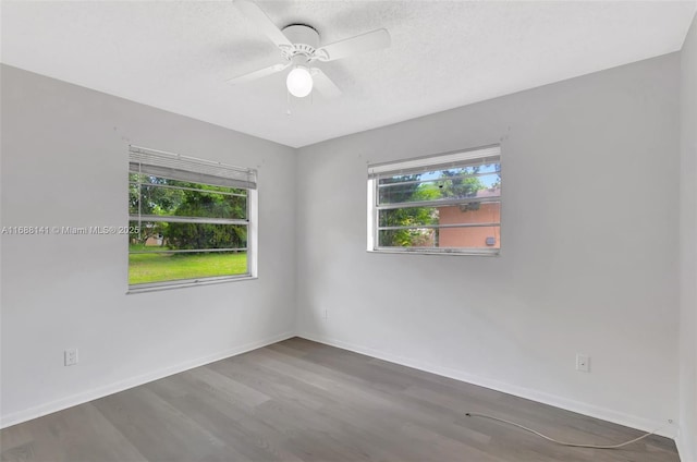 1101 SW Addie St, Port St Lucie, FL 34983 - empty room featuring healthy amount of natural light, wood finished floors, and a ceiling fan