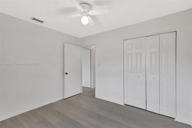 1101 SW Addie St, Port St Lucie, FL 34983 - unfurnished bedroom featuring wood finished floors, a closet, and a ceiling fan