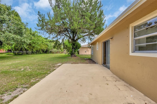 1101 SW Addie St, Port St Lucie, FL 34983 - view of grassy yard with a patio area