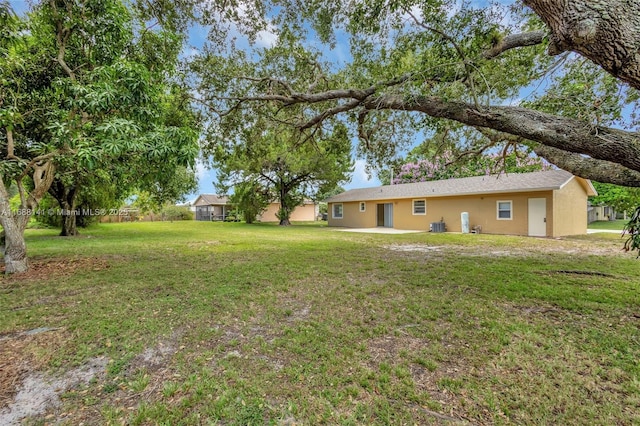 1101 SW Addie St, Port St Lucie, FL 34983 - view of green lawn with a patio