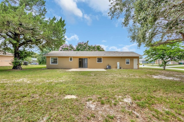 1101 SW Addie St, Port St Lucie, FL 34983 - back of house featuring a patio area, stucco siding, and a yard
