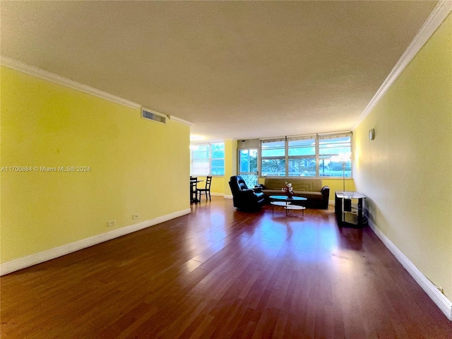 unfurnished living room with crown molding and dark hardwood / wood-style flooring