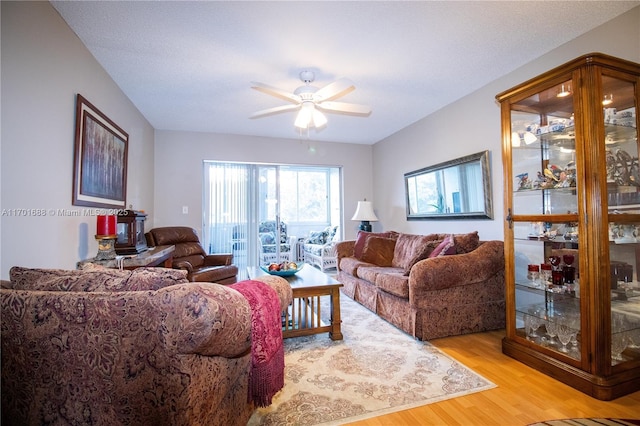 living area with ceiling fan and light wood-style floors