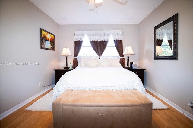 bedroom with hardwood / wood-style floors and ceiling fan