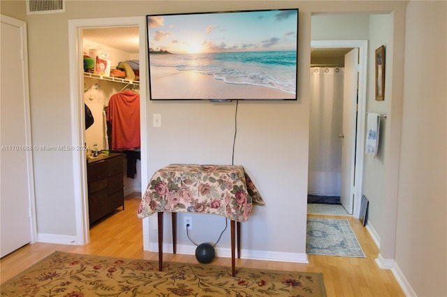 hallway with light hardwood / wood-style floors