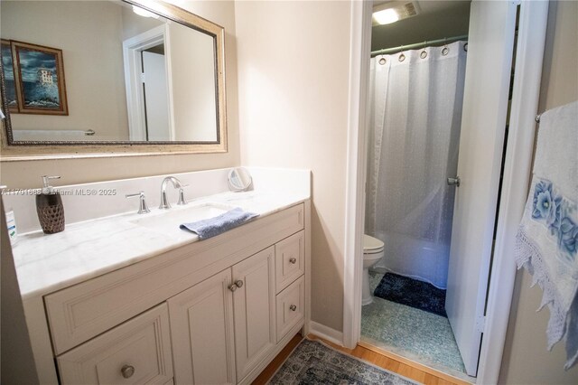 bathroom with a shower with shower curtain, vanity, wood-type flooring, and toilet