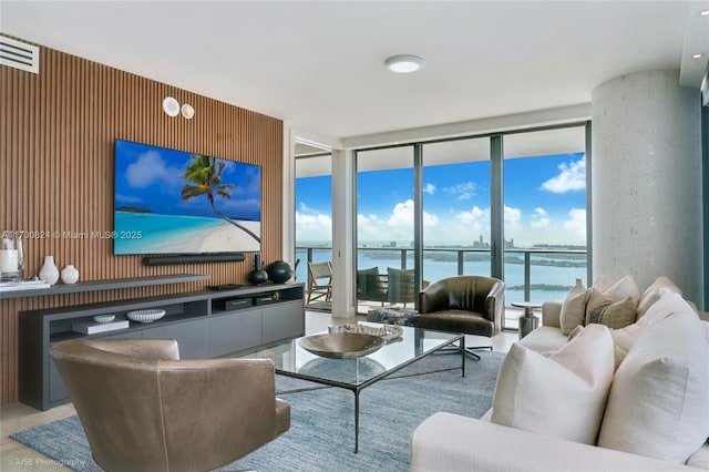 living area featuring visible vents and floor to ceiling windows