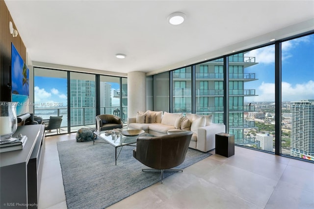 living area with a city view, expansive windows, and tile patterned floors