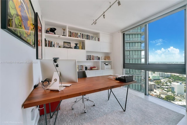 office area with plenty of natural light, expansive windows, and tile patterned flooring